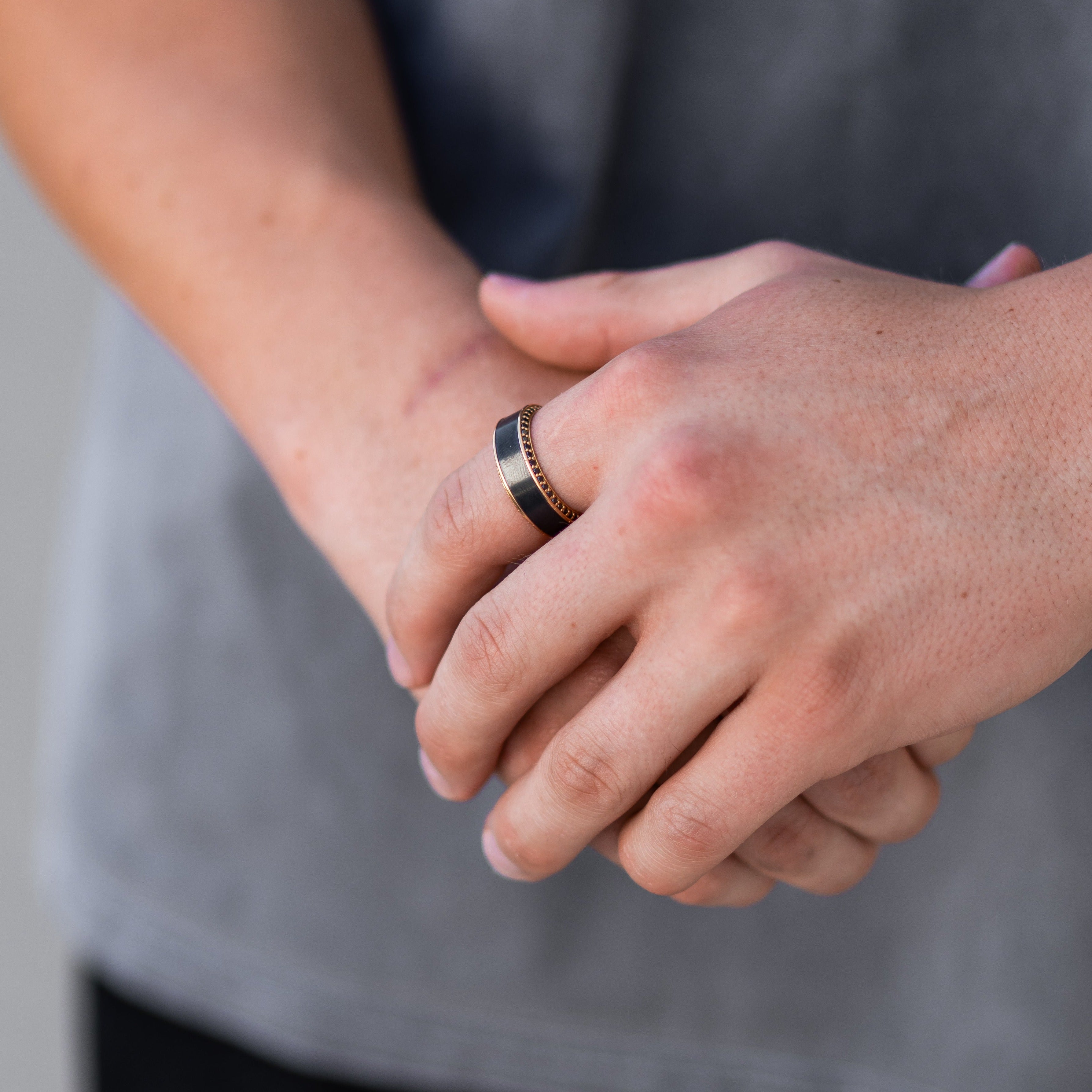 Lifestyle shot #3 of men's hands wearing our HELIOS Rose Gold Band, Black Diamond Inlay, and Black Diamond Insets | ElysiumBlack.com | Men's Black Diamond Wedding Ring