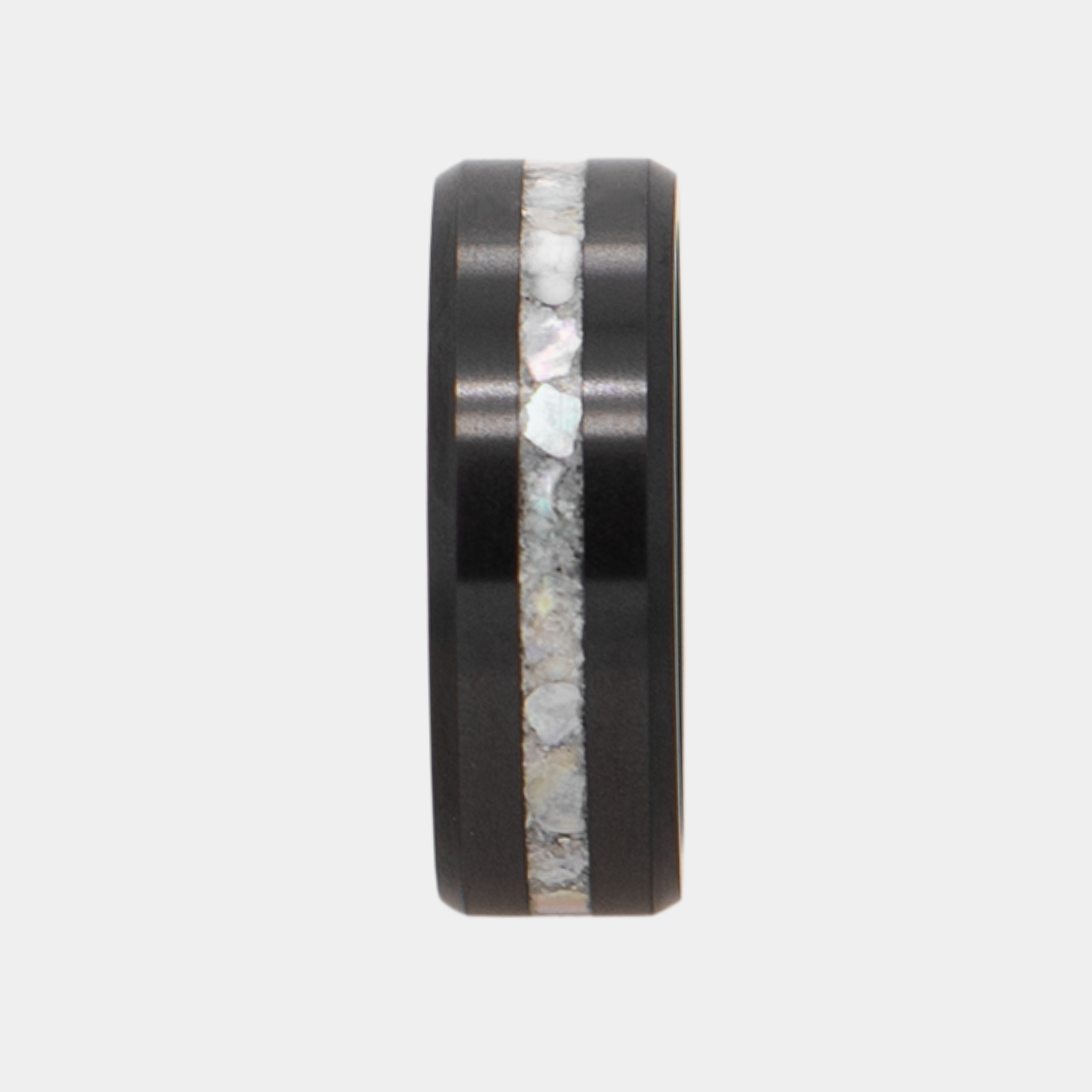 Vertical view of Solid Black Diamond ring with a crushed mother of pearl inlay on a light gray background