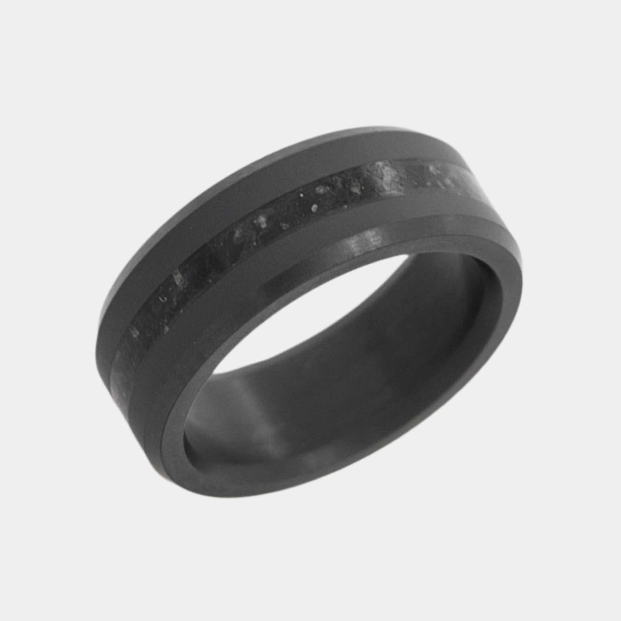 Solid Black Diamond ring with obsidian inlay on a light gray background