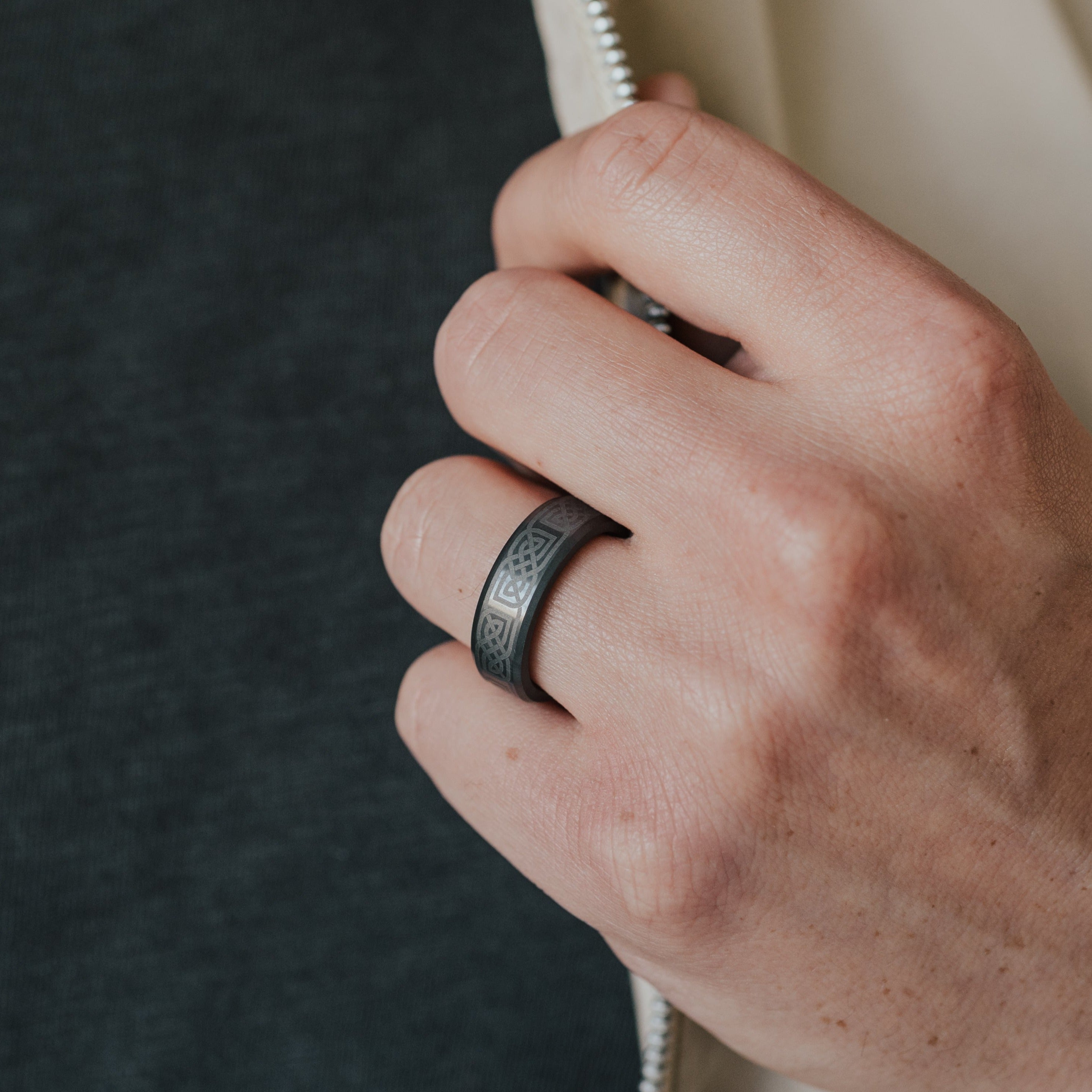 Lifestyle shot #1 of men's hands wearing our Men's Black Diamond Celtic Laser Engraved Ring | Elysium KRATOS | Black Diamond Ring | Mens Celtic Rings | Celtic Rings for Him