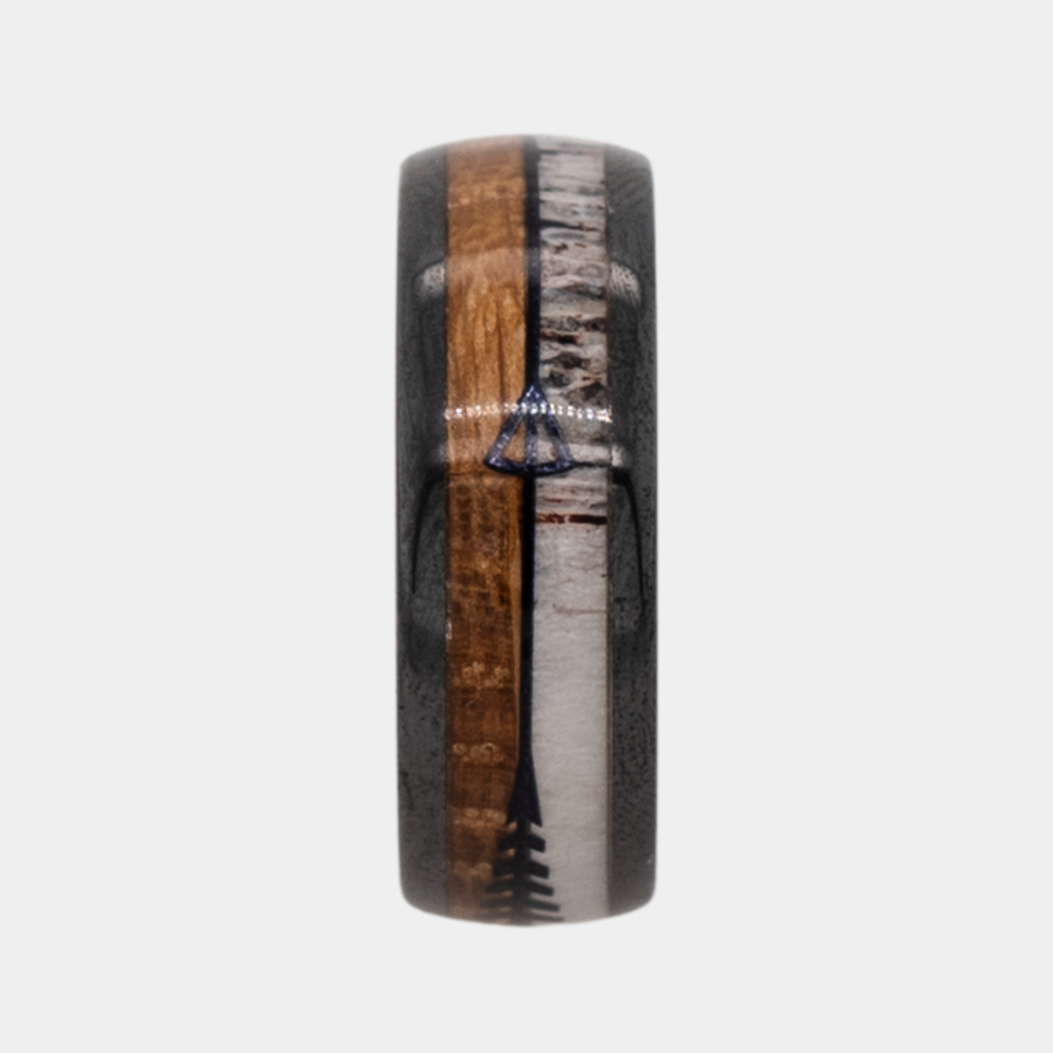Eros ring – polished Black Ceramic featuring Whiskey Barrel Wood, Deer Antler and Black Arrow Foil part of the Hustler Collection. Ring standing upright to show profile and thickness.