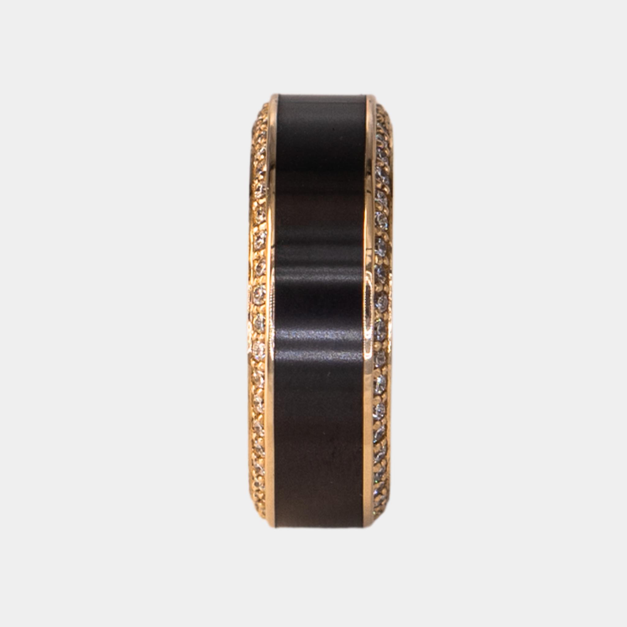 HELIOS ring – 8mm black diamond men’s ring with a yellow gold band, black diamond inlay, and white diamond insets. Ring standing upright to show the 8mm band profile and clean yellow gold band edges.