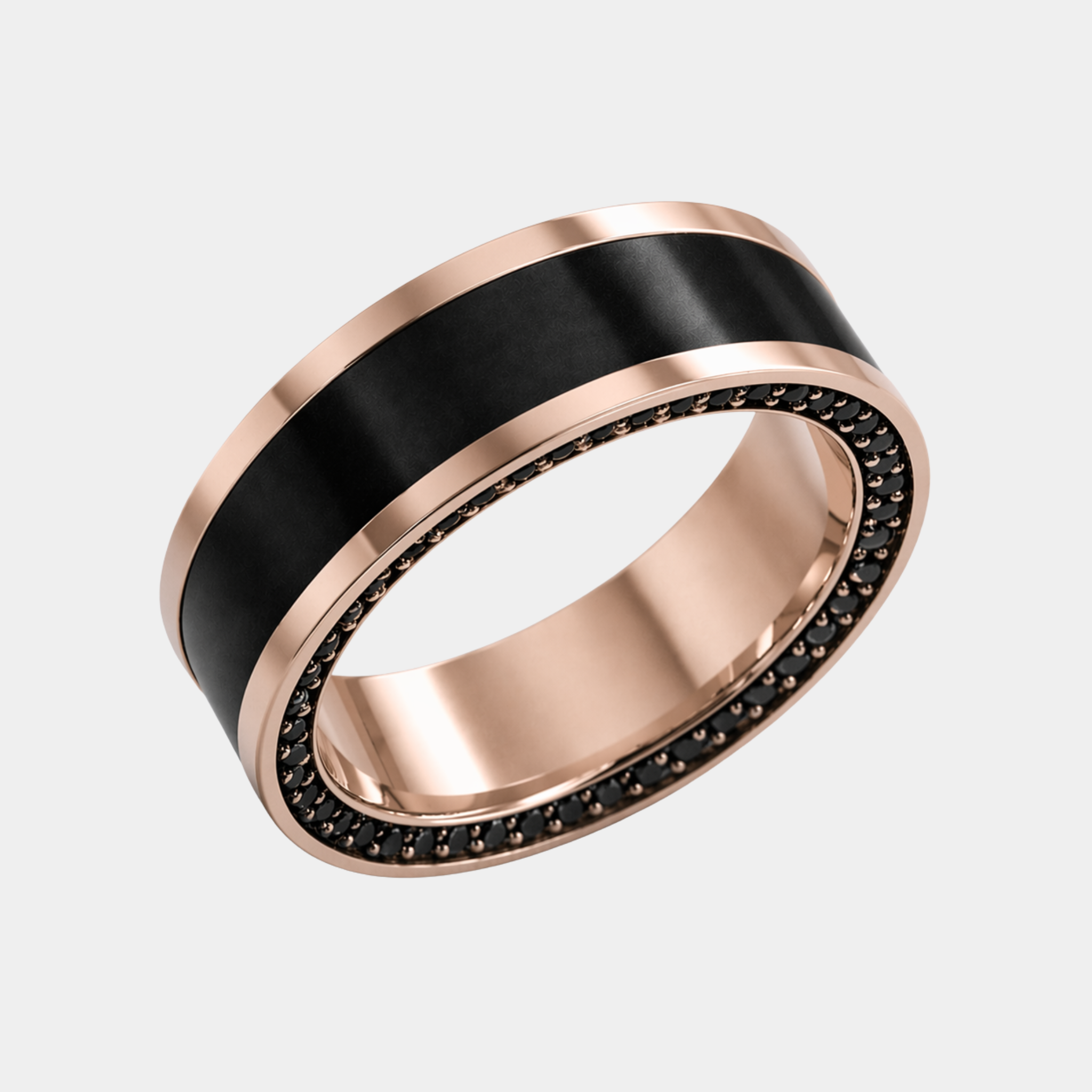 A rose gold reverse inlay ring with a solid black diamond inlay and a row of small black stones around the inner edge.