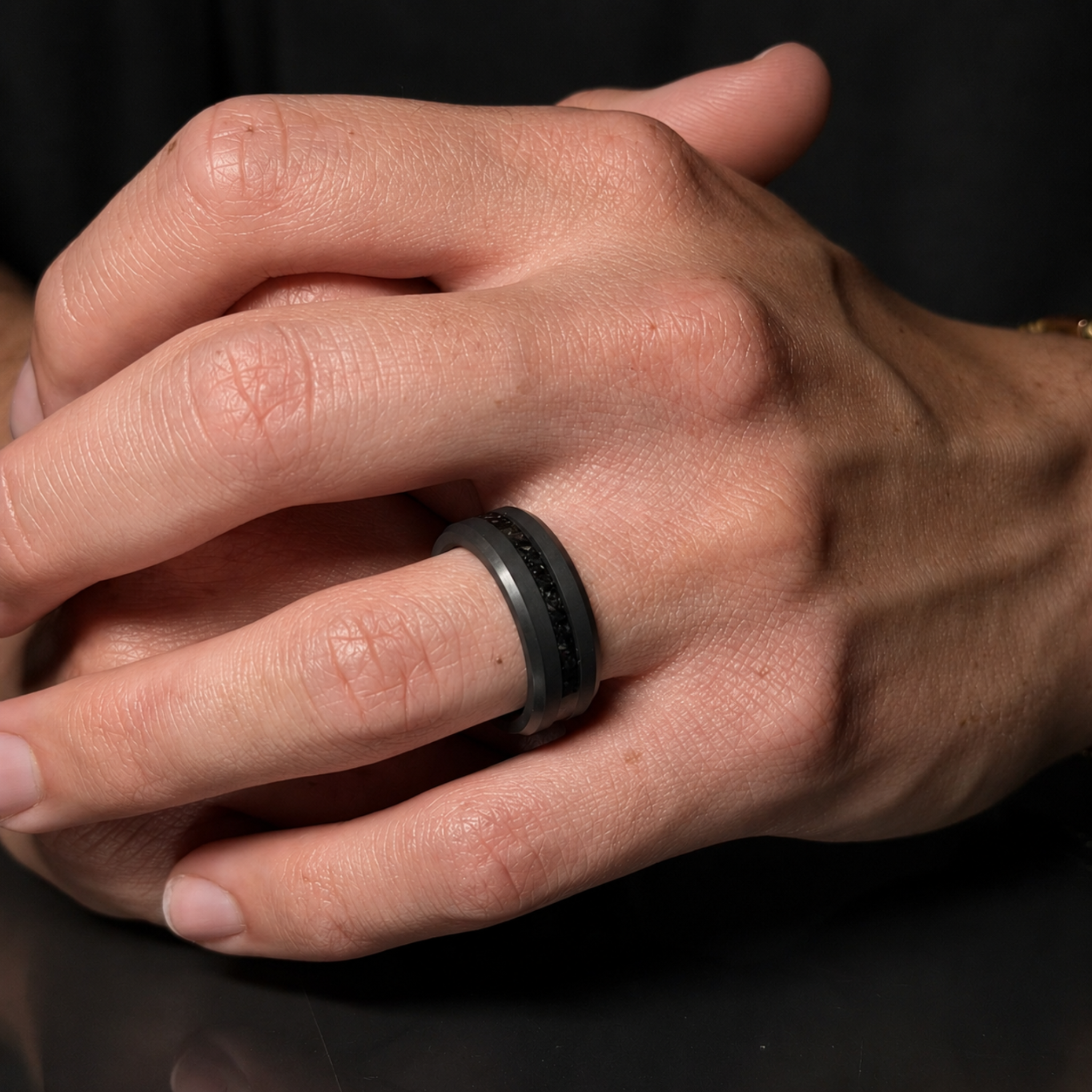 ARES solid black diamond wedding band with centered obsidian inlay worn on hand