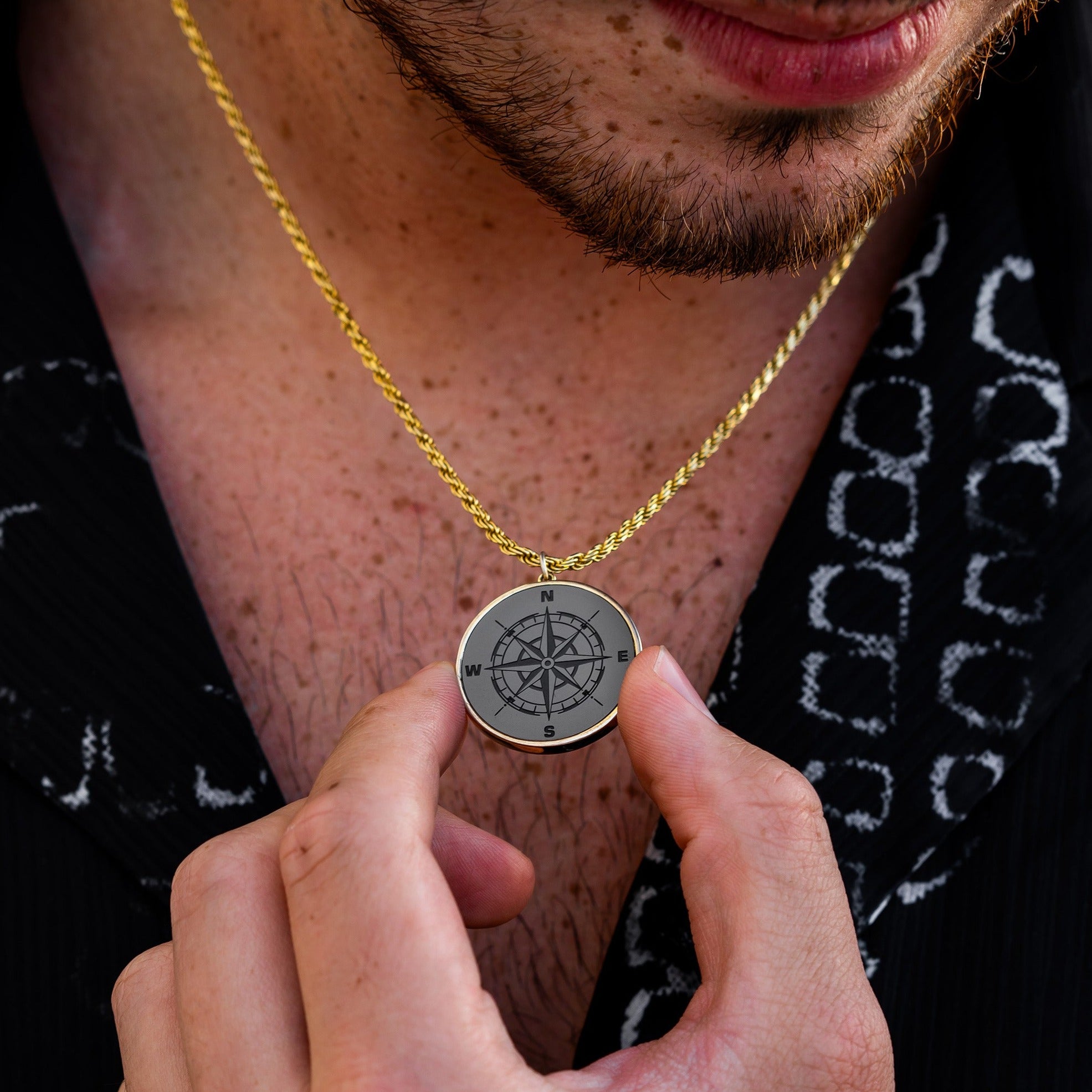 Lifestyle shot #1 of man holding our Men's Black Diamond Necklace & 26mm Custom Pendant with 14k Vermeil Gold Shrouded Franco Chain | Black Diamond Necklace Men