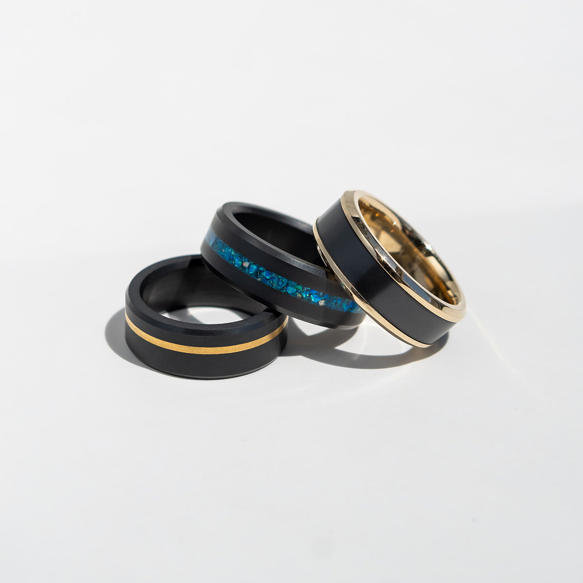 Display of Three Different Black Diamond Wedding Bands with Yellow Gold & Blue Inlays | Inlay Black Diamond Rings | Collections | Elysium Black Diamond