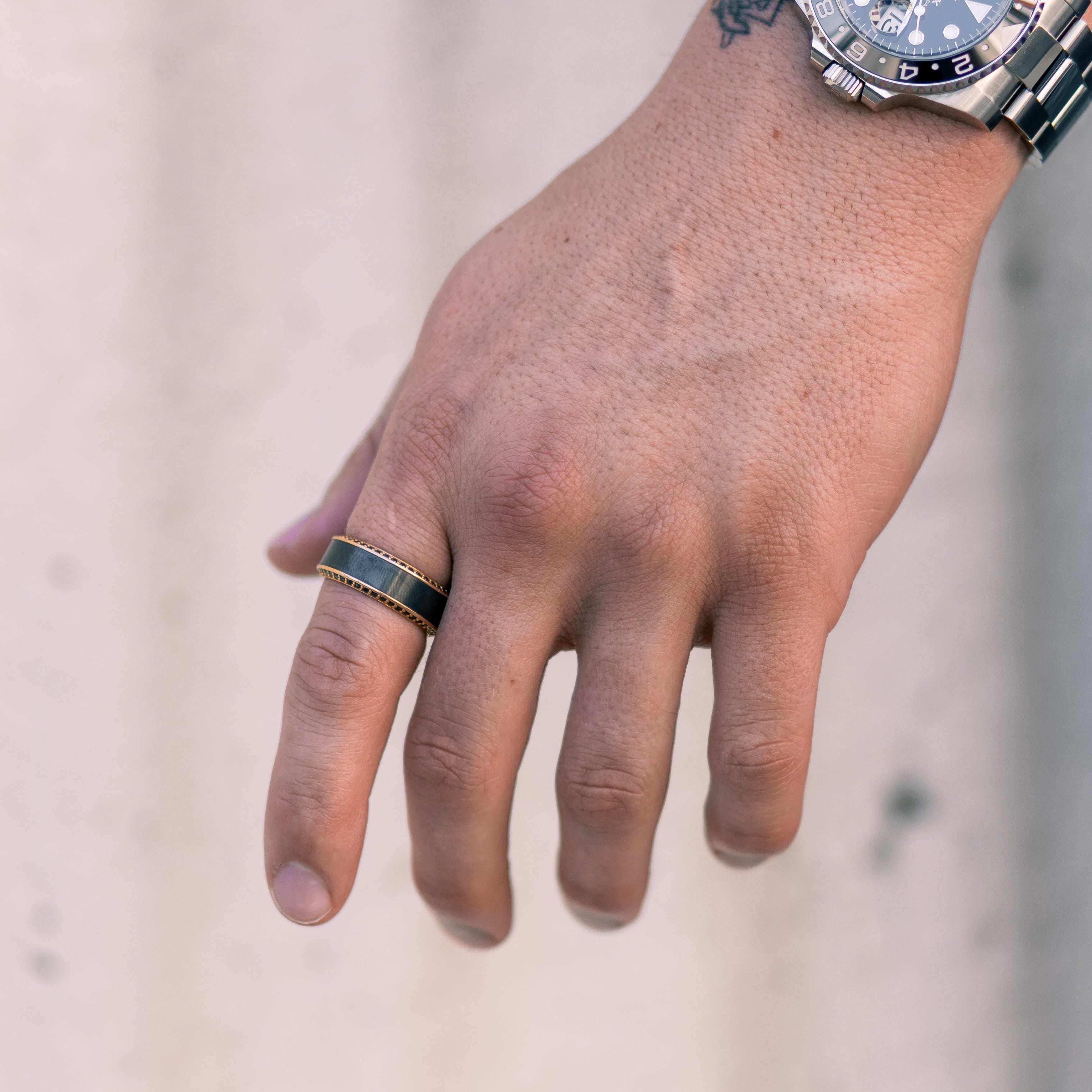 Lifestyle shot #2 of men's hands wearing our HELIOS Rose Gold Band, Black Diamond Inlay, and Black Diamond Insets | ElysiumBlack.com | Men's Black Diamond Wedding Ring