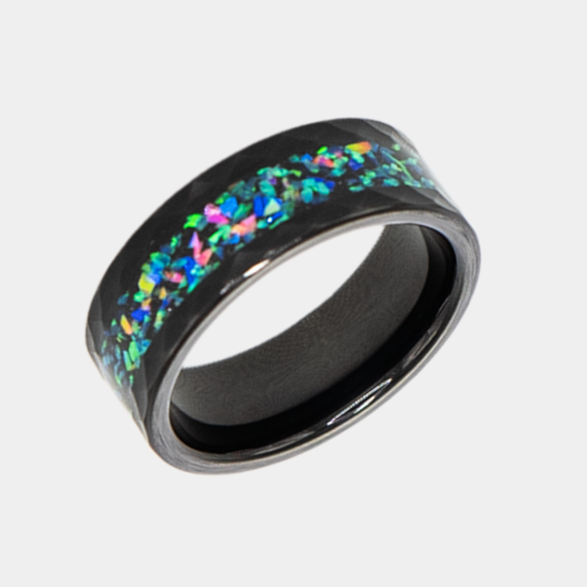 Aeolus ring – Hammered Black Tungsten, Crushed Opal Inlay from the Hustler Collection. Angled view highlighting shape and finish.