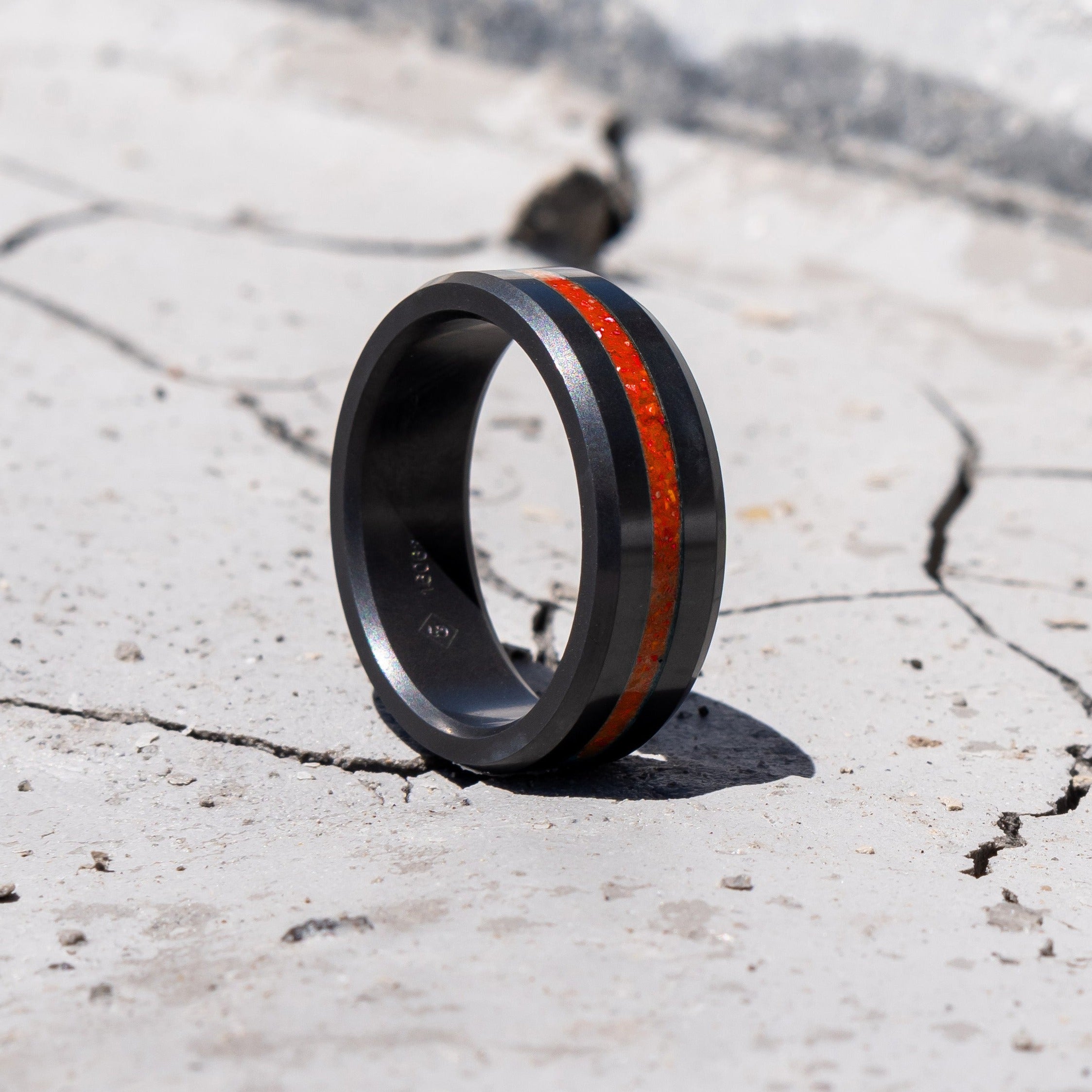 Ring shot #1 of our Elysium ARES Men's Black Diamond & Red Opal ring resting on a marble surface | ElysiumBlack.com | Men’s Opal Rings | Opal Rings for Men