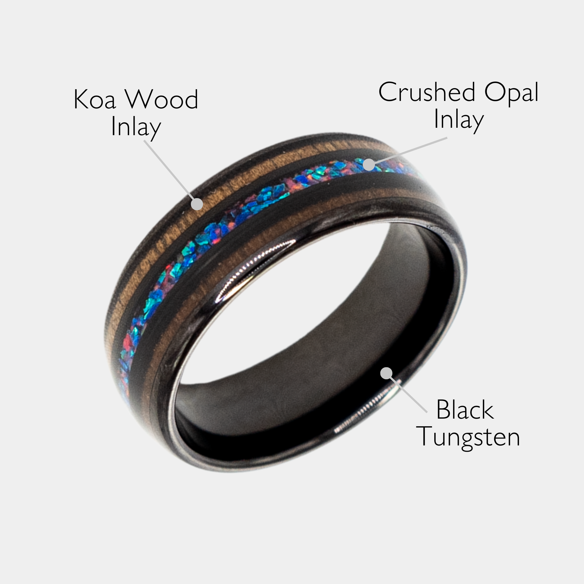 Nereus ring – Black Tungsten featuring Double Koa Wood and Crushed Opal Inlays from the Hustler Collection.  Angled view with product name overlay.