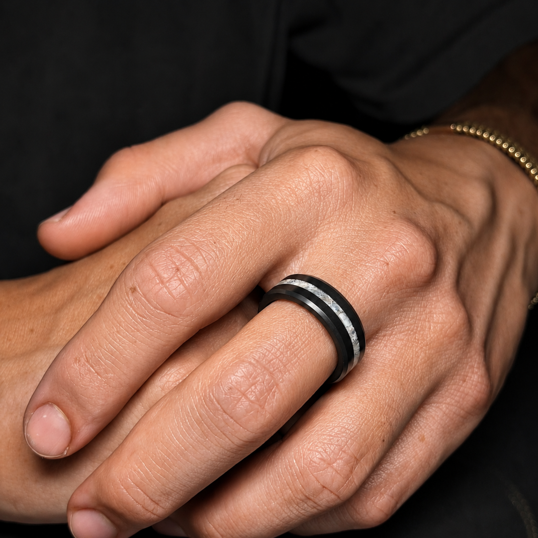 ARES solid black diamond wedding band with centered crushed pearl inlay worn on hand