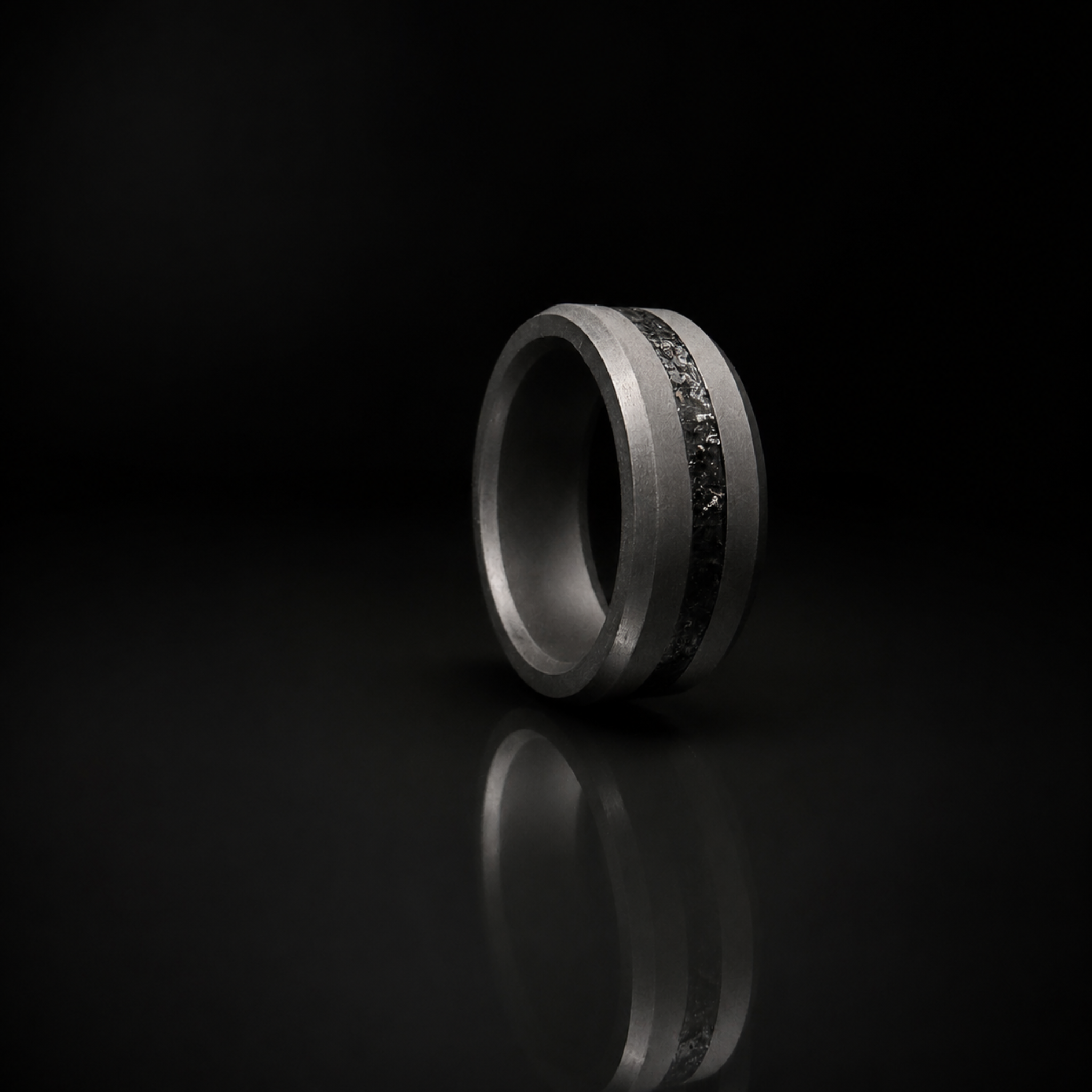 ARES obsidian inlay ring in solid black diamond on dark editorial surface